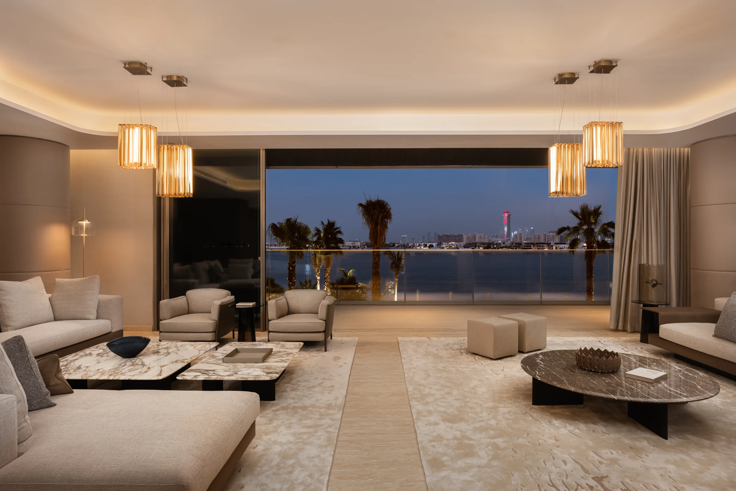 The Reserve living room at dusk with Palm view